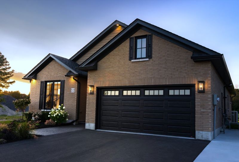 Brick home with double garage and paved driveway