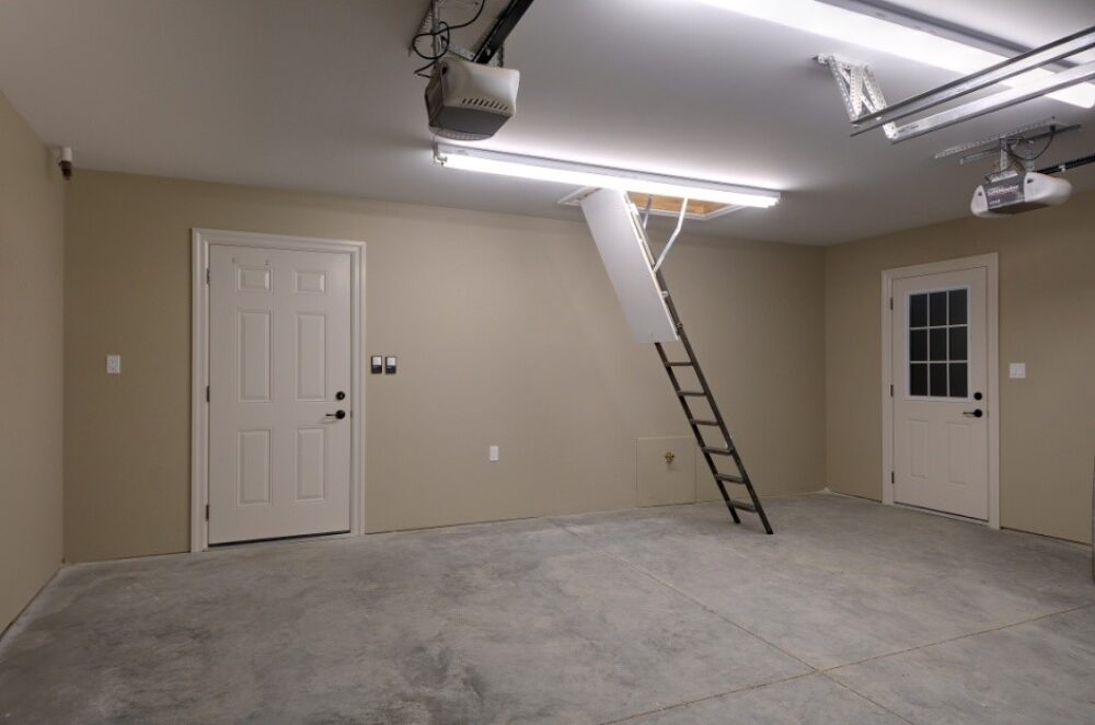 Inside of garage showing a garage loft and pull down ladder